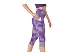 Woman in purple patterned capri leggings with a phone in the side pocket.