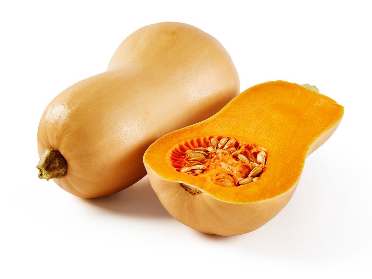 Cijela i prepolovljena butternut tikva s vidljivim sjemenkama