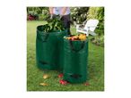 Two green garden waste bags filled with leaves and branches on a lawn