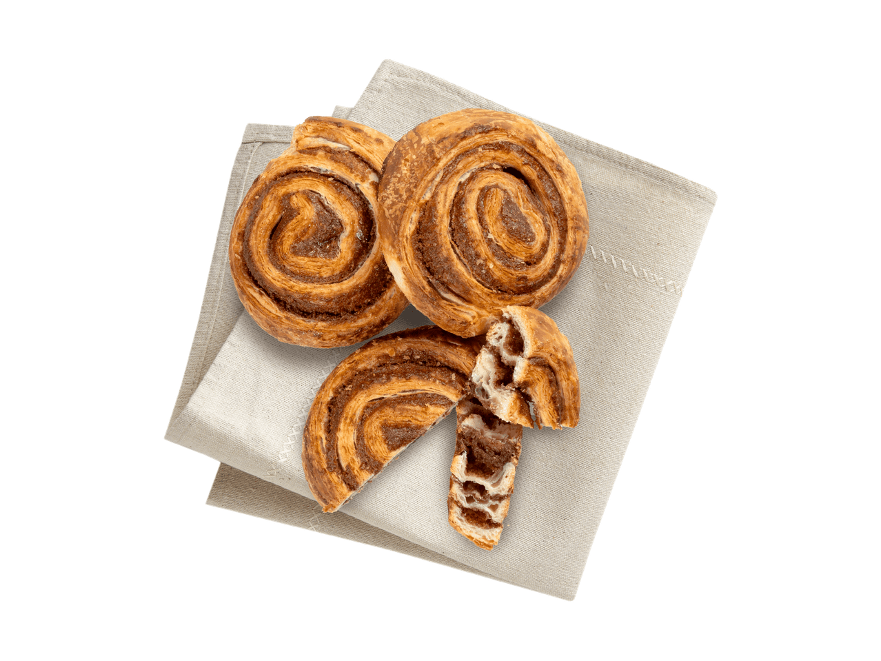 Zwei Zimtschnecken und eine zerbrochene Zimtschnecke auf einem Leinentuch