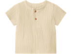 Light beige short-sleeved baby shirt with a round neck and two wooden buttons.