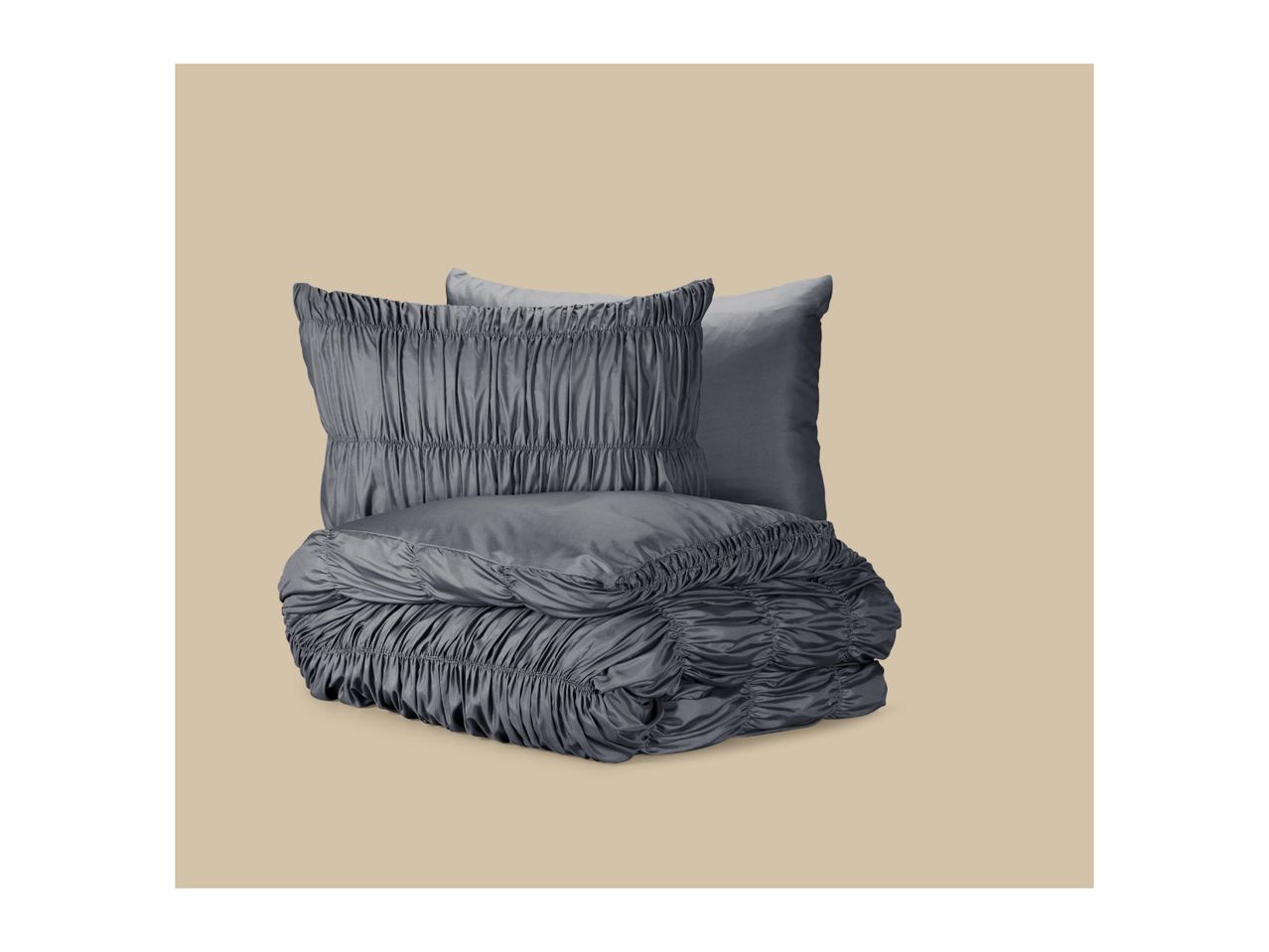 Grey ruched bedding set with a folded duvet and two matching pillows