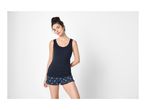 Woman in a navy blue tank top and floral print shorts.