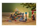 Wooden building blocks with sea creatures and Christmas gifts on a wooden floor.