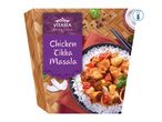 Chicken Tikka Masala with rice, served in a bowl on a woven mat, chilled.