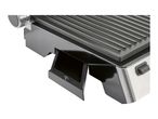 A close-up shows a removable drip tray on a contact grill.