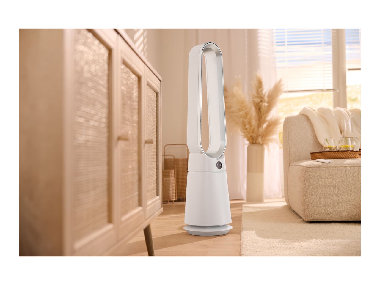 White air purifier in a bright living room with a wooden cabinet and beige sofa.
