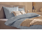 Livarno Microfibre Satin Bedlinen in light blue with a grid pattern, styled with decorative pillows.