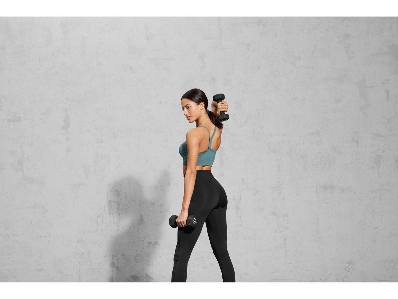 Woman working out with dumbbells.