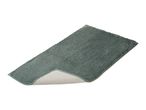 A rectangular green bath mat with a non-slip backing.