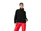 Woman in black fleece and red ski pants with ski goggles and beanie