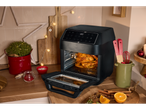 Silvercrest® Kitchen Tools 9-in-1 Air Fryer with a whole chicken inside, surrounded by kitchen tools.