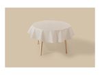 Round table with a light beige tablecloth on a matching background.