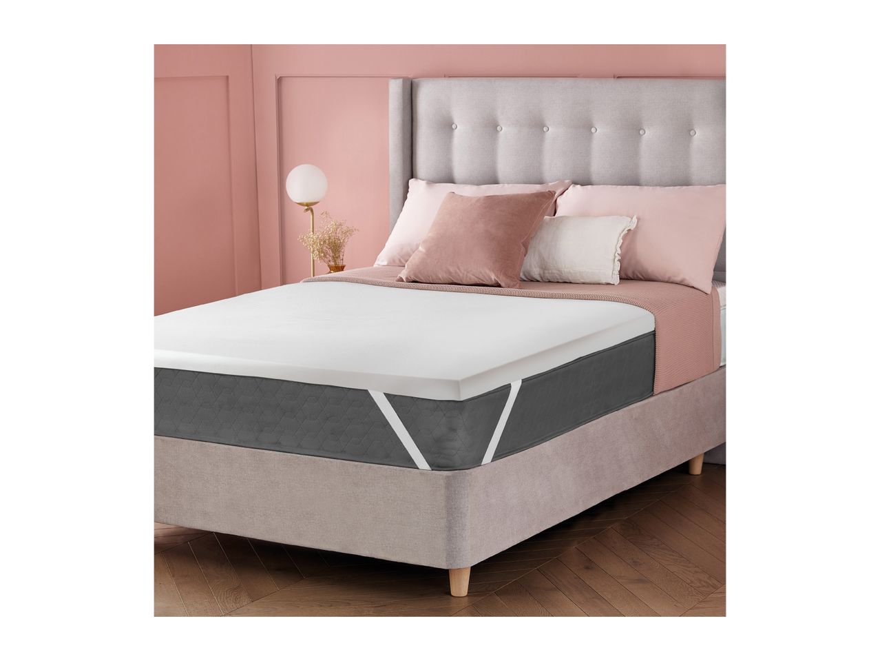 Bedroom with a bed, mattress topper, and pink and grey bedding.