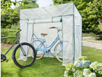 Two bicycles, one blue and one grey, stored inside and next to a transparent bicycle storage tent in a garden.
