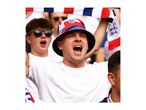 Excited football fan in a bucket hat and white t-shirt, cheering with open mouth.