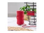 Red macrame cord spool next to a black wire basket being wrapped with the thread.