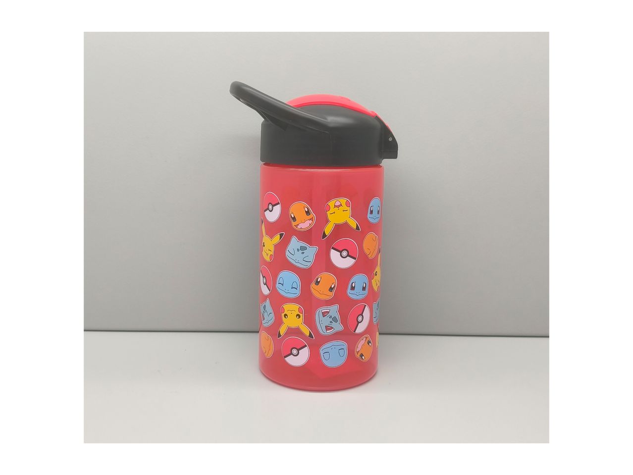 Red Pokémon water bottle with a black and red lid, featuring various Pokémon characters and Poké Balls.
