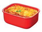 Lasagna in a red rectangular baking dish, garnished with parsley.