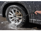 PARKSIDE pressure washer cleaning a dirty car wheel with foam.