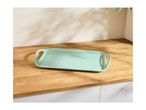 Mint green rectangular serving tray with white polka dots on a wooden countertop.