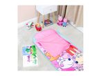 Pink sleeping bag with cartoon characters, toys, and books on a light-colored carpet.