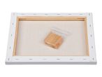 Back of a stretched canvas with a wooden frame and a small bag of wooden wedges.