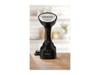 Black handheld garment steamer with a brush attachment on a wooden surface.