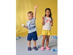 Lupilu Kids' T-Shirts: boy in blue shark tee, girl in white rainbow tee, playing with balls.