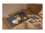 Doormat with a fox and pumpkins, next to a pair of slippers and a woven basket.
