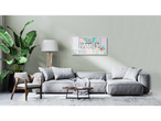 Grey sofa, picture frame with family photos and flowers.