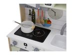 A close-up of a child's play kitchen with a pot, whisk, and sink.