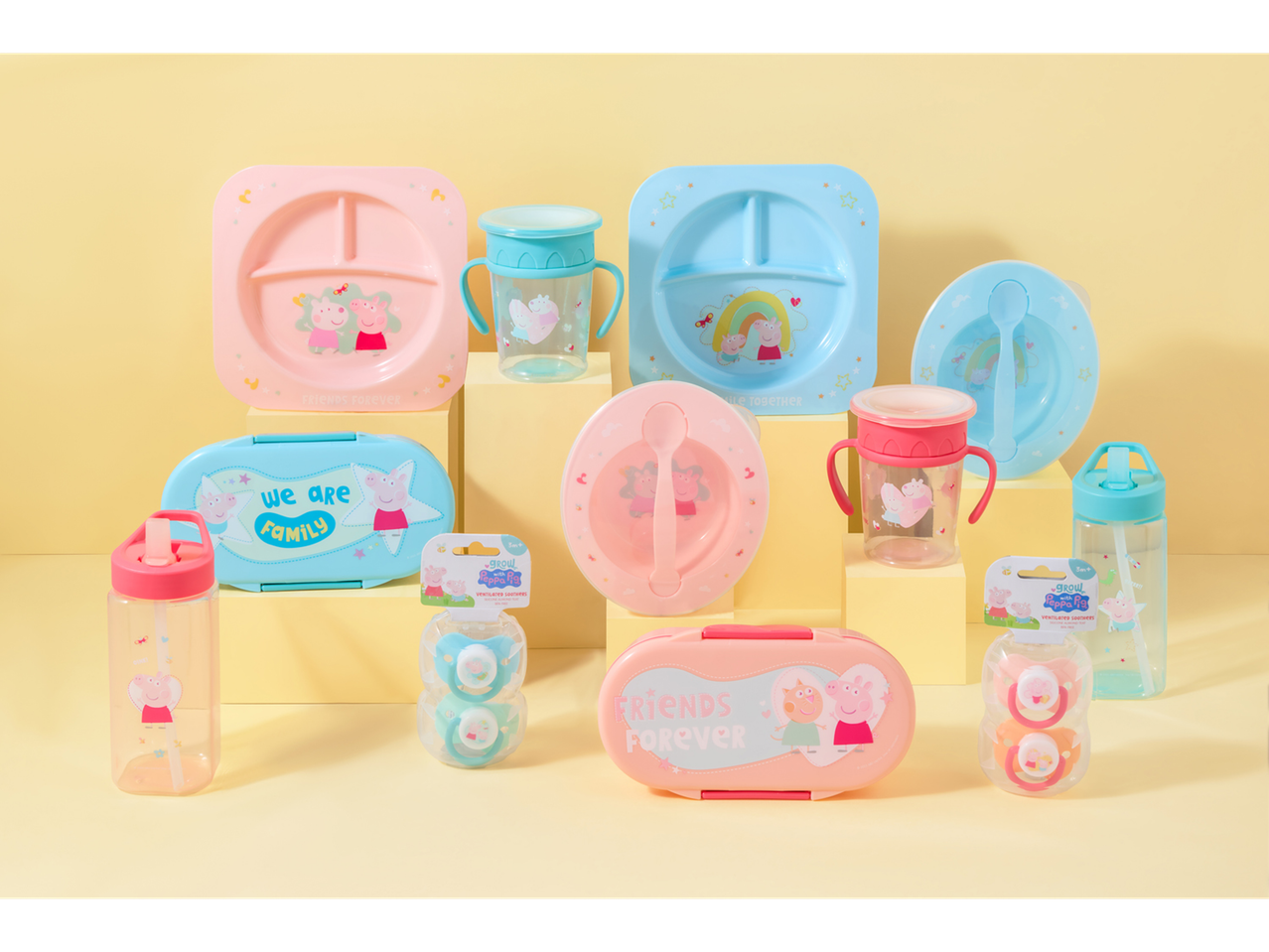 A collection of Peppa Pig themed children's dinnerware, bottles, and pacifiers.