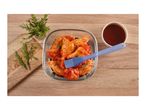 Marinated chicken wings with rosemary and barbecue sauce on a wooden table.