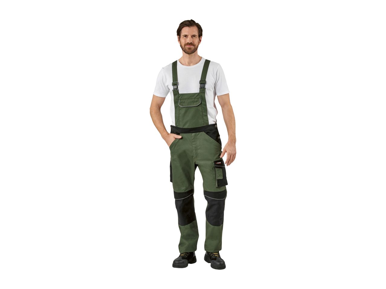 Man in green and black work overalls with a white t-shirt and work shoes.