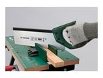 Hand saw cutting wood on a workbench with a miter box.