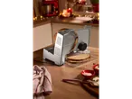 Electric slicer with freshly sliced bread in a festive kitchen.