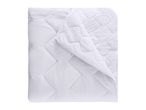 White quilted duvet, folded with a corner turned over, on a white background.
