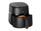 A black air fryer with food inside.
