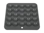 A gray silicone mat with multiple suction cups is shown.