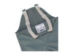 Close-up of green waterproof dungarees with adjustable straps and a name tag.