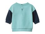 Baby's teal and navy blue long-sleeved top with snap buttons.