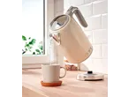 SILVERCREST® Kettle pouring hot water into a mug on a wooden counter.