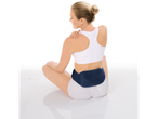 Woman using a back pain patch.