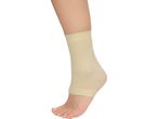 A person's foot and lower leg wearing a beige ankle support sleeve.