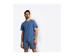 Man wearing a blue t-shirt and striped boxer shorts.