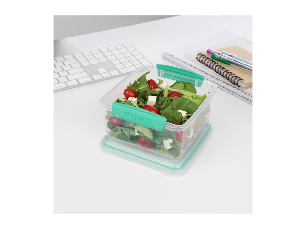Sistema food container with fresh salad on a desk.