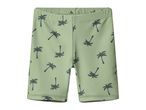 Green swim shorts with a dark palm tree pattern for children.