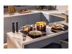 Elegant copper cookware set with pots and pans on a modern kitchen island hob.