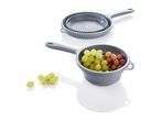 Grey silicone colander and strainer set with grapes.